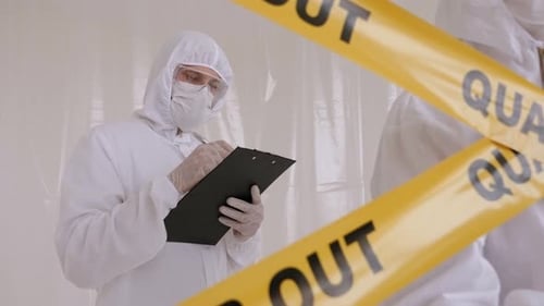 Medical Staff in Protective Suits Taking Notes