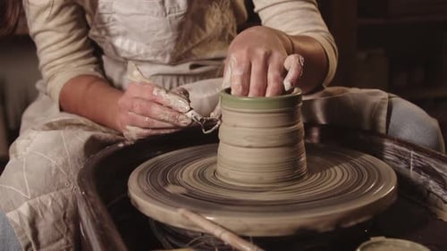 Pottery Workshop Female Hands Fixing the Clay Shape Using a Tool on the Sides