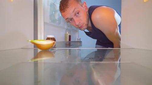 Man Checking the Empty Refrigerator for Food