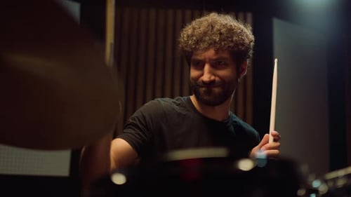 Smiling Drummer Having Fun in Studio. Musician Playing on Drum Cymbals Indoor.