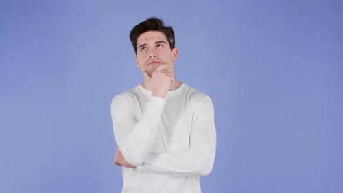 Young Thinking Pondering Man Having Idea Moment Pointing Finger Up on Violet Studio Background