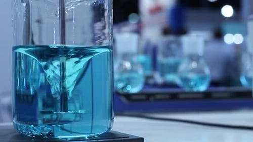 Blue Liquid Stirring in Glass Beaker