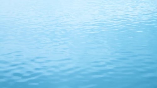 Gentle Ripples on the Tranquil Blue Water Surface
