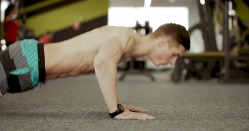 Young Adult Doing Push-Ups in Gym