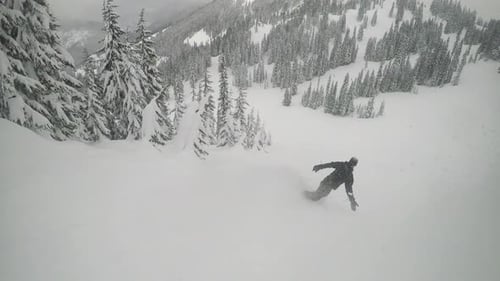 Snowboarder Slashing Powder Cloud Follow Cam