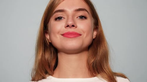 Smiling Young Woman with Red Lipstick Winking