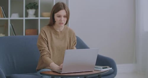 Call Center Agent Wear Headset Video Calling Laptop. Business Woman Wears Headset Talks Web Camera