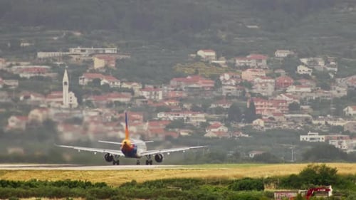 The Testament is Not a Video of a Plane Taking Off From a Runway in a Cityscape