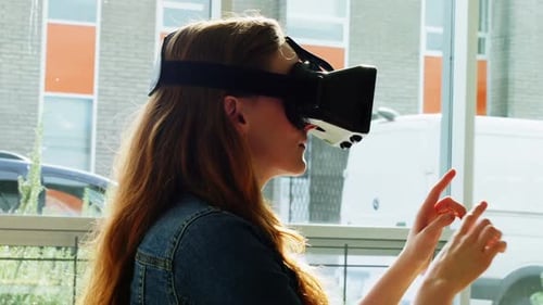 Woman Uses VR Headset in Urban Office