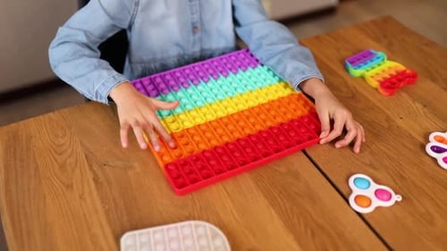 Little Girl Playing with Big Silicone Popit Simple Dimple Bubble Fidget Toy