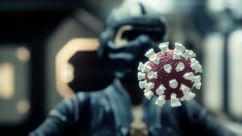 Woman in Protective Medical Mask on Her Face Looking at COVID-19 Coronavirus