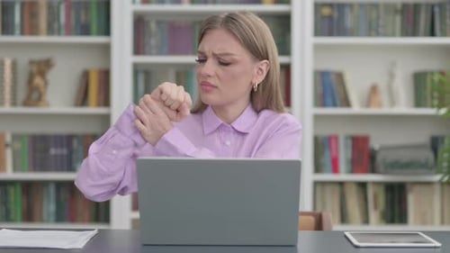 Woman Having Wrist Pain While Using Laptop in Office