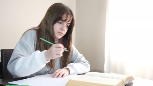 Student Studying and Writing at Home