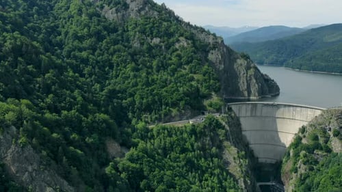 Aerial View of a Hydroelectric Dam in the Mountains Covered with Forest