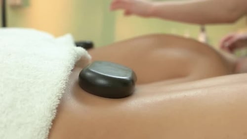 Man Receiving Hot Stone Massage at the Spa
