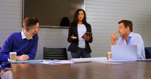 Woman Leading Meeting with Colleagues in Modern Office