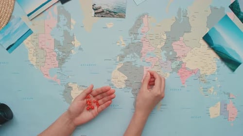 Mapping Journeys with Red Push Pins on World Map