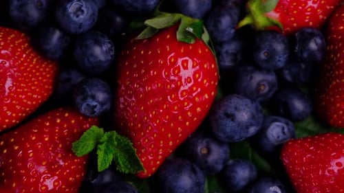 Closeup of Red Fresh Strawberry and Blueberry with Leaves