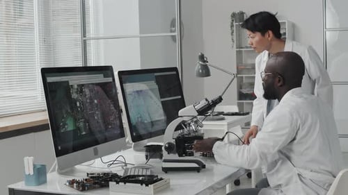 Scientists Working With a Microscope in a Lab