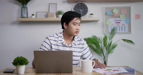 Asian businessman checking corporate paperwork correspondencev