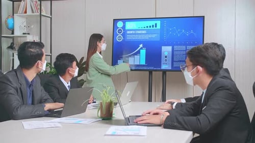 Business Presentation in Office with Data Charts