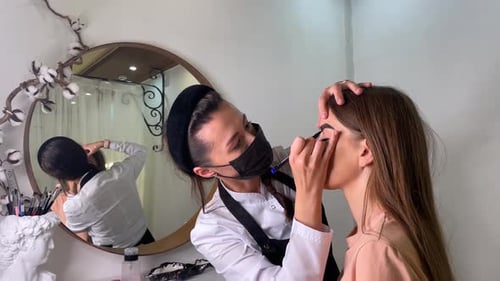 Makeup Artist Applying Makeup in Beauty Studio