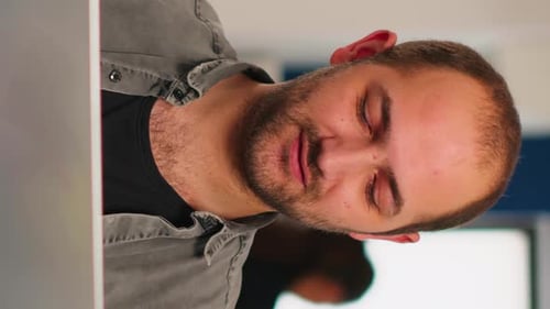 Man Working at Laptop Close Up Vertical Format