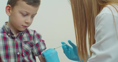 Child Receiving a Vaccine in Doctor's Office