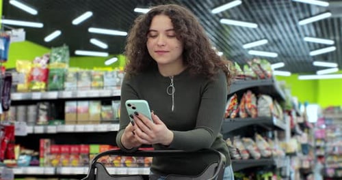 Beautiful Woman Use Smartphone in Supermarket