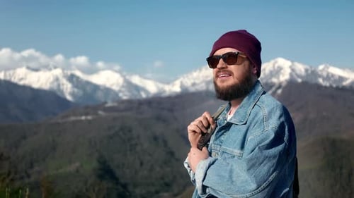 Bearded Hipster Male Traveler Contemplating Sunny Sky Mountain Snowy Peak Landscape Travel Vacation