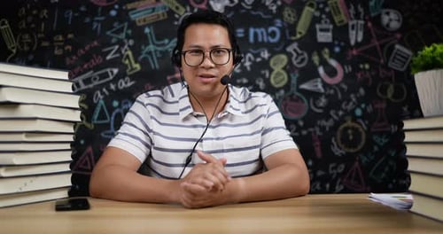 Man at Desk Explaining Educational Material