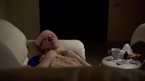 Person Lying on Couch with Medicine