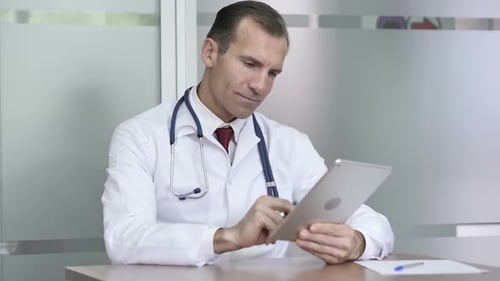 Doctor Using Tablet for Internet Browsing