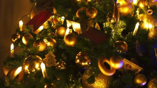Decorated Christmas Tree with Golden Ornaments and Lights