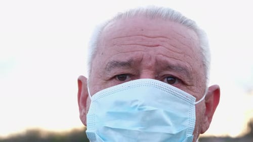 Senior Adult Wearing a Surgical Mask Close Up