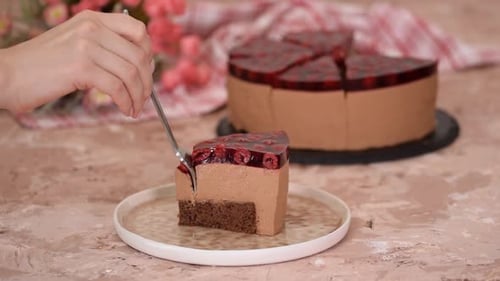 Close Up of Fork Cutting Chocolate Mousse Cake