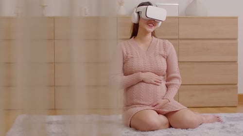 Pregnant Woman Smiling Using VR Headset Indoors