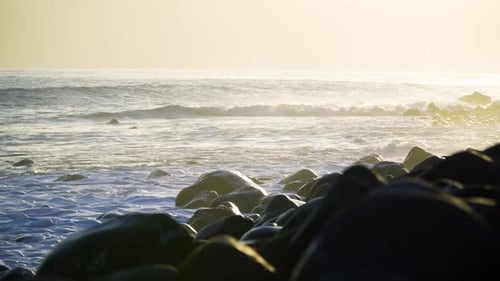 Waves Crashing on Rocky Beach at Golden Hour