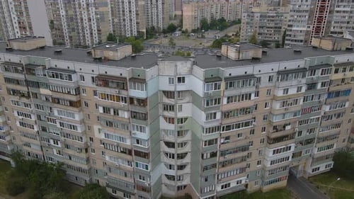 Aerial view tilting away from soviet made old apartment buildings, cloudy day, in Kiev, Ukraine - Pu