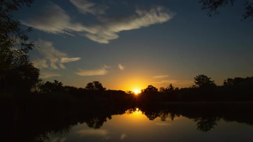 Tranquil Sunrise Over Lake Time Lapse