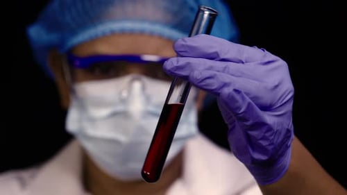 Scientist Examines Blood Sample in Test Tube