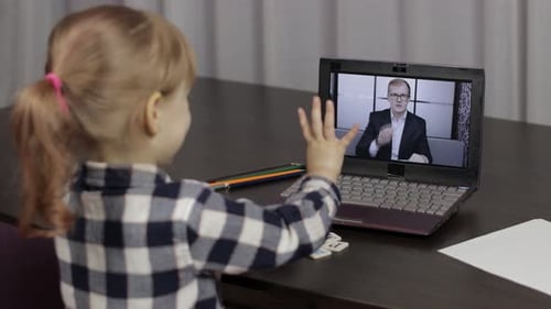 Child Learning Alphabet With Online Teacher on Laptop