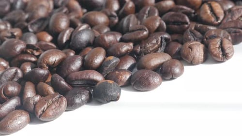 Close-up panning on dark roasted coffee beans 4K video