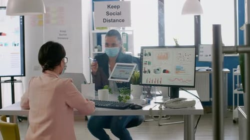 Women Analyze Data Together in Modern Office