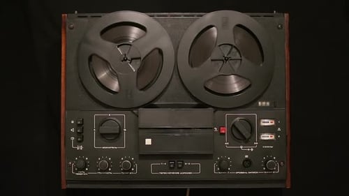 Vintage Reel-to-Reel Tape Recorder Playing Back Music