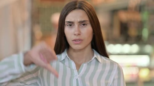 Woman Making Thumbs Down Gesture with Hand
