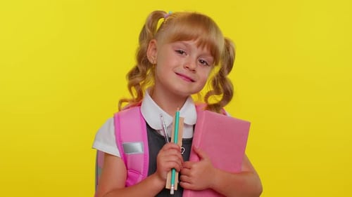Funny Positive Kid Primary School Girl with Ponytails Wearing Uniform Smiling on Yellow Background