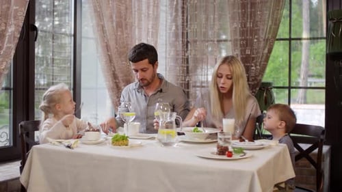 Family of Four Eating in Restaurant