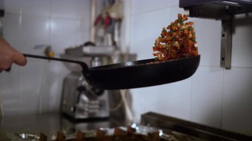 Chef Tossing Vegetables in a Frying Pan