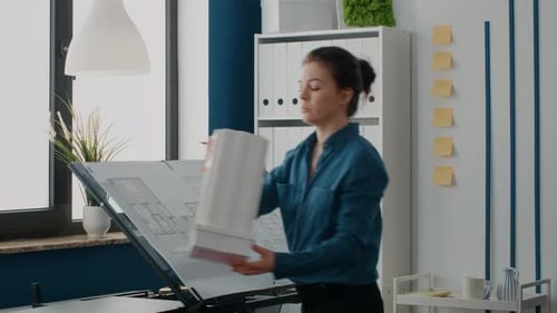 Close Up of Women Analyzing Building Model and Maquette Structure to Design Blueprints